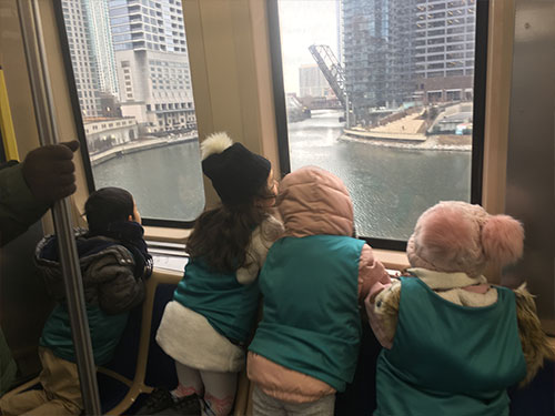 Photo of children looking out at a river in Chicago